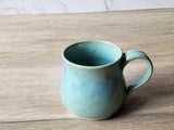 Rustic green ceramic mug with glossy interior
