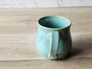Wheel-thrown pottery mug with rounded comfort form