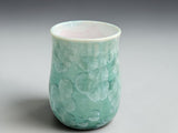 Front view of handmade green crystalline ceramic coffee mug