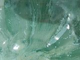 Close up of a Handmade pottery serving bowl with twin compartments, crafted from durable stoneware clay and finished in Buxton Pottery's signature mottled green glaze.