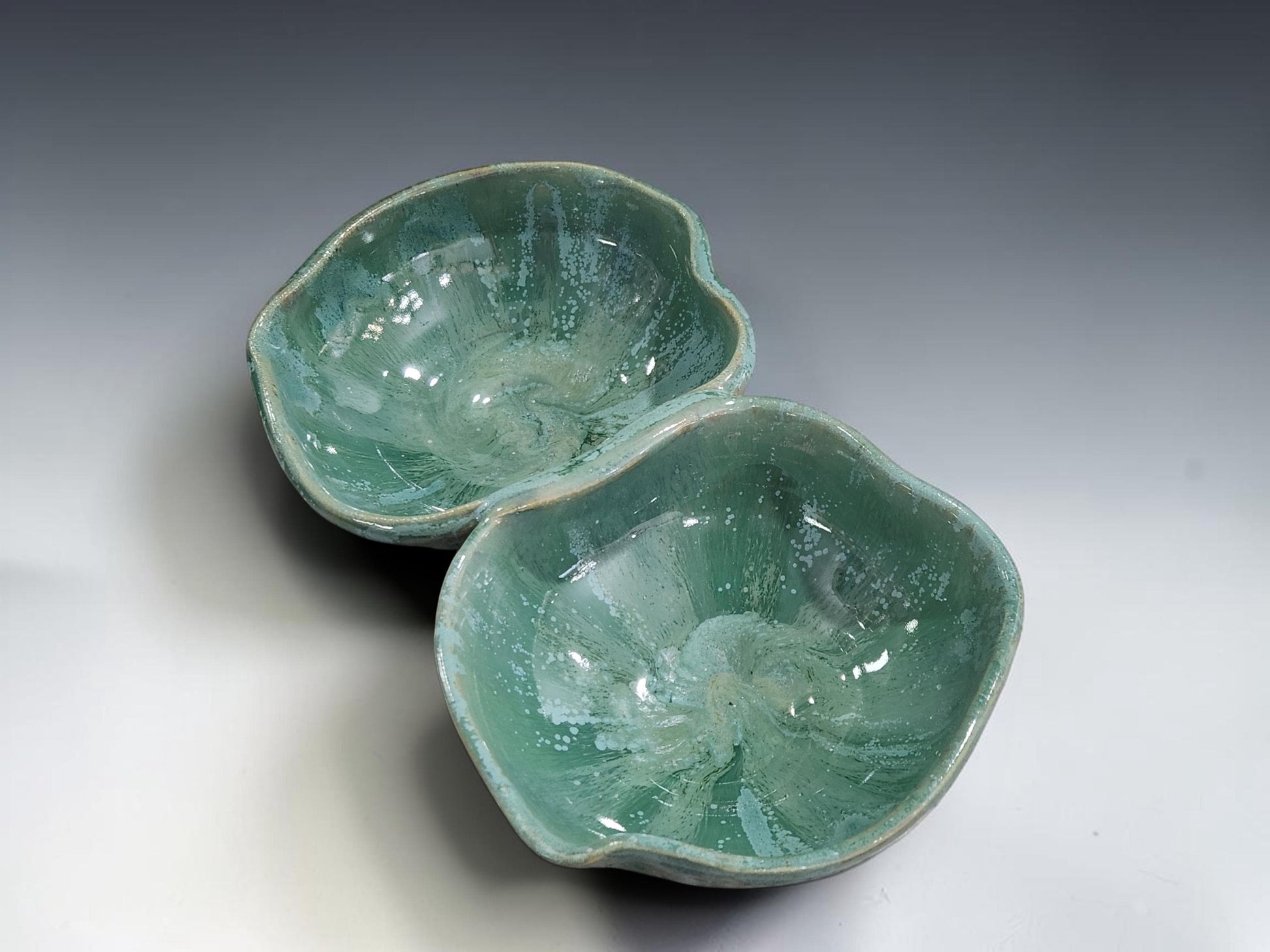 Handmade pottery double snack bowl with mottled green glaze, crafted in Melbourne for serving olives, nuts, dips and shared appetisers.