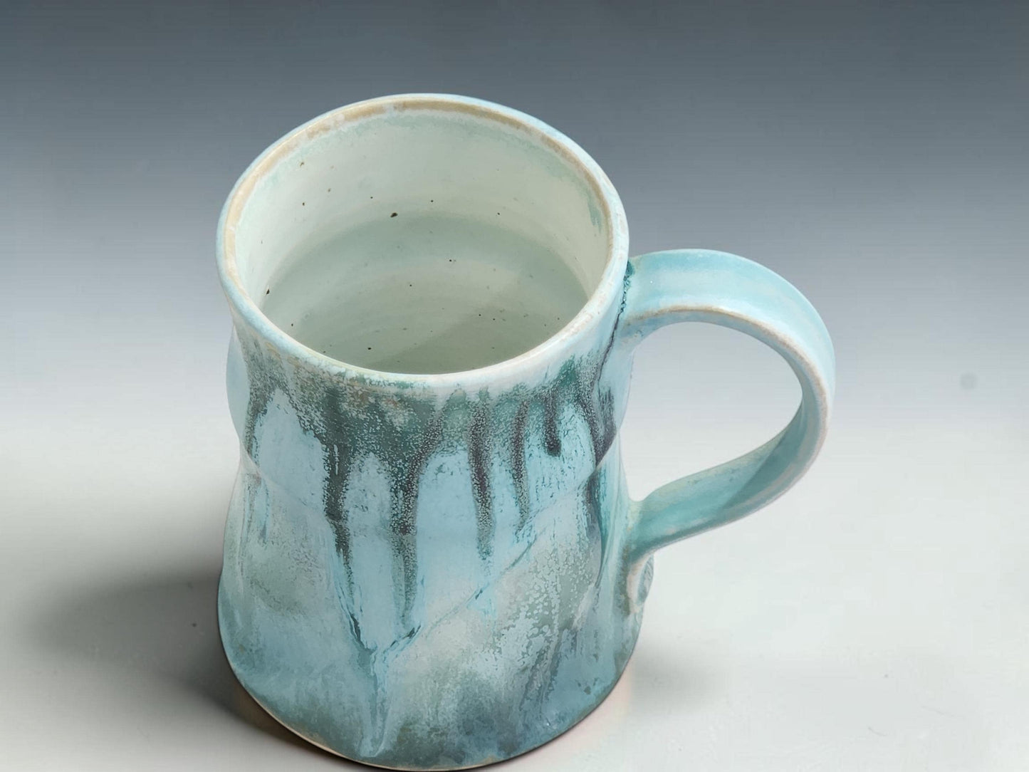 Artisan ceramic coffee mug handmade in Australia with unique soft turquoise glaze