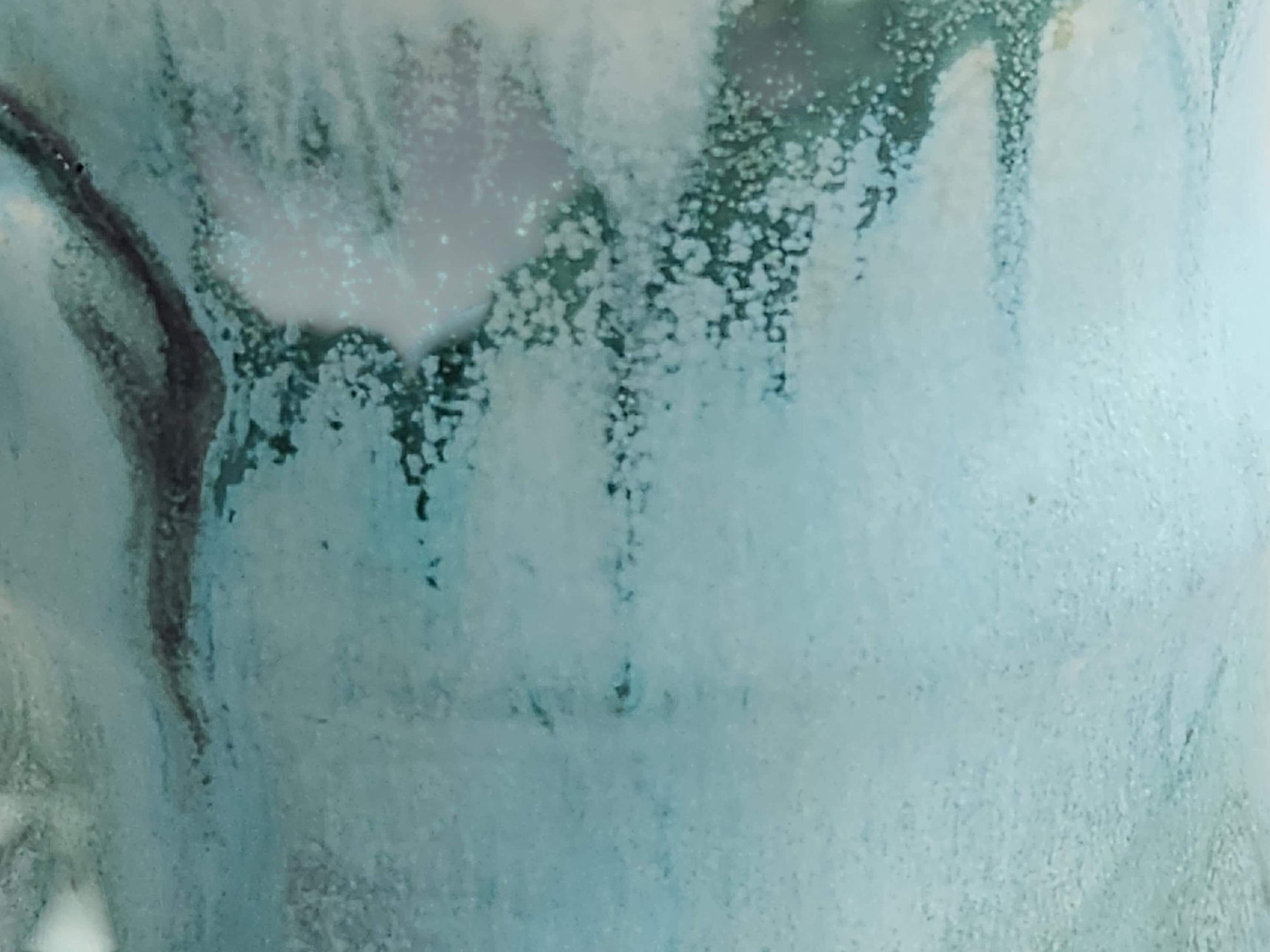 Close-up of flowing misty blue and eucalyptus green glaze on Australian handmade pottery mug