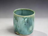 Bush Creek Collection ceramic tumbler with flowing green glaze and natural handmade variation