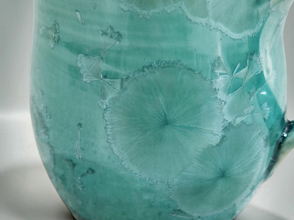Close-up of naturally formed crystals in a green porcelain glaze