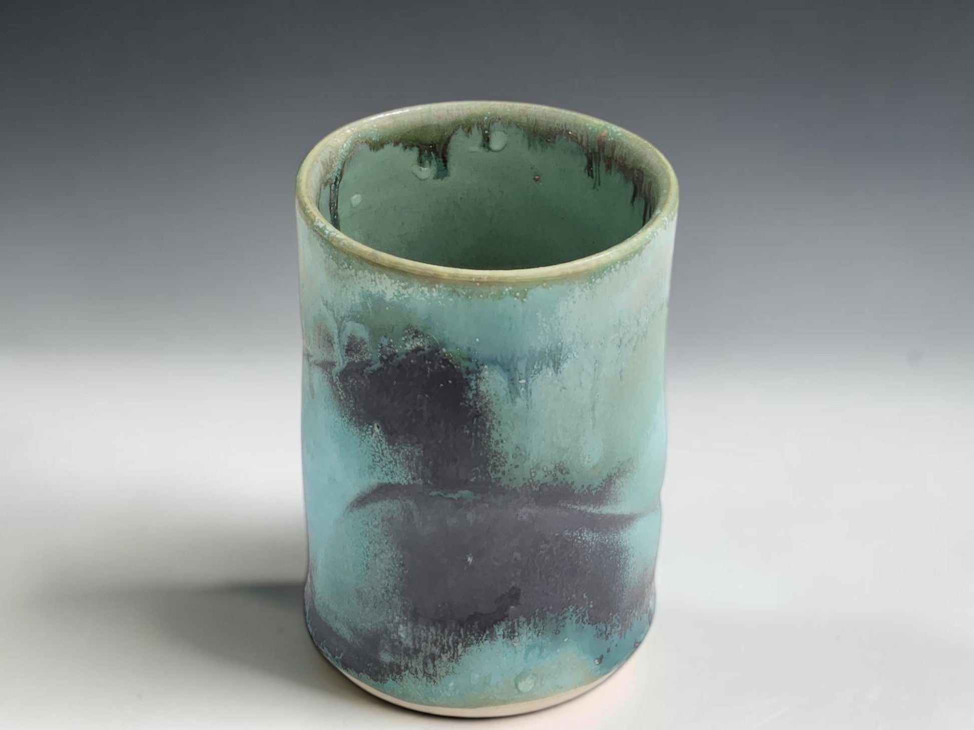Wheel-thrown pottery cup in green blue glaze, handmade in Melbourne studio