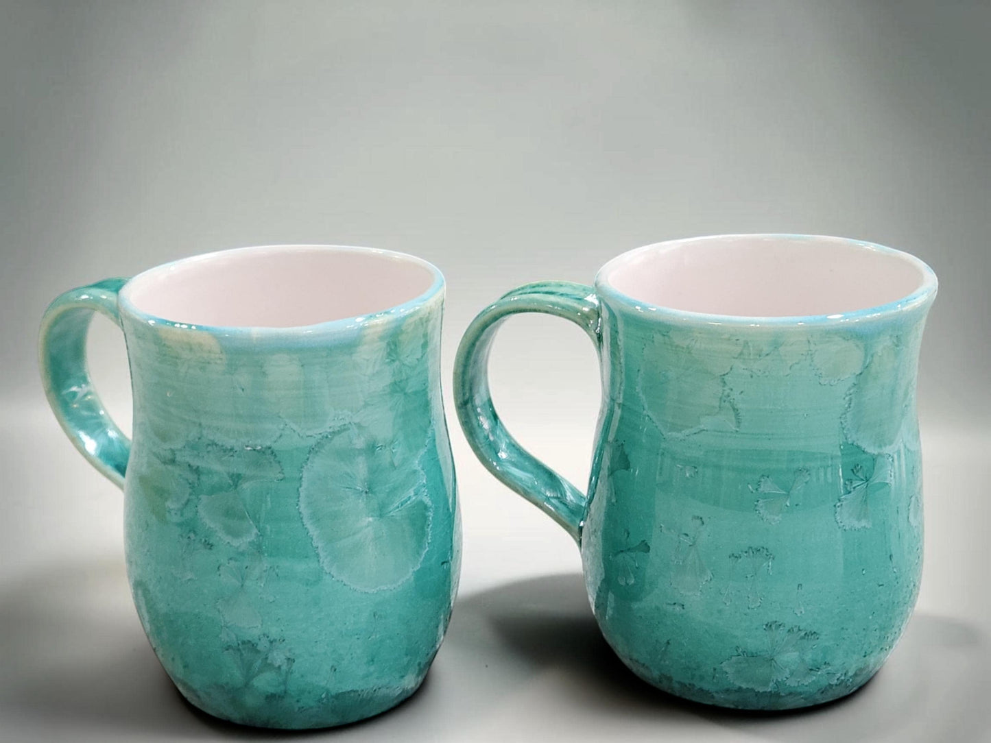 Side view of green crystalline porcelain mug showing rounded shape