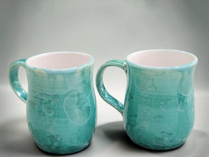 Side view of green crystalline porcelain mug showing rounded shape