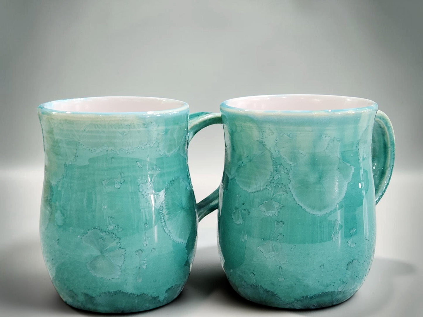 Handmade 350 ml porcelain coffee mug with green crystalline glaze
