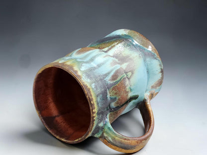 Buxton Pottery handmade mug with red brown interior and layered Bush Creek exterior glaze