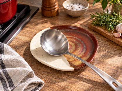 Large handmade pottery spoon rest with ladle in kitchen lifestyle setting
