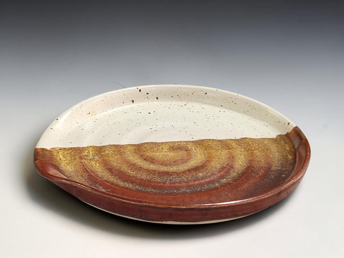 Large ceramic spoon rest showing hand-thrown concentric pottery detail
