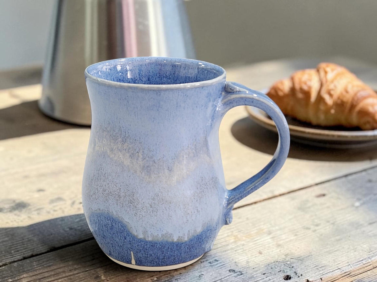 image of 500ml handmade mottled blue ceramic coffee mug with croissant