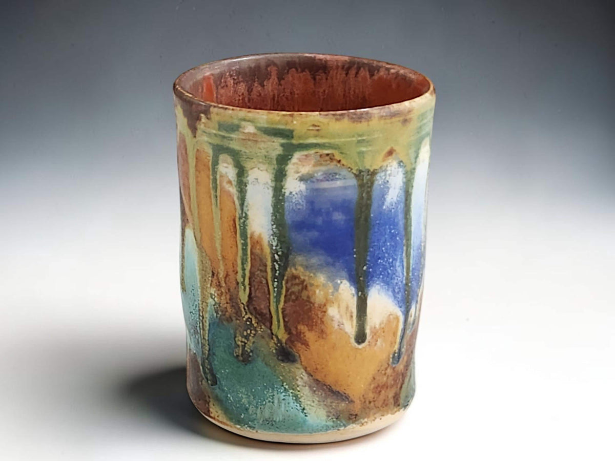 Handmade pottery tumbler with blue green turquoise and earthy brown glaze