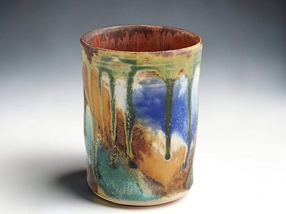 Handmade pottery tumbler with blue green turquoise and earthy brown glaze