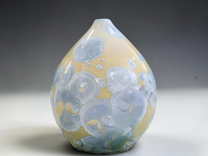 Detail of the bud vase with tapered shoulders of the handmade blue and cream pot.