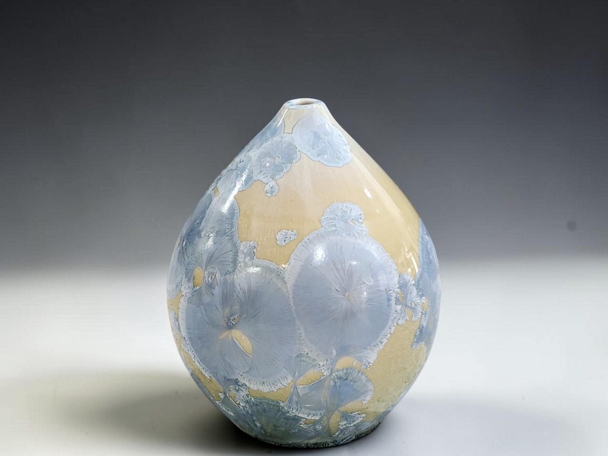 Front view of the handmade crystalline pot showing its rounded belly and gently tapered top.