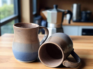 Large handmade pottery mug with oatmeal brown and sky blue glaze