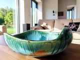 Handmade ceramic fruit bowl with green and aqua glaze