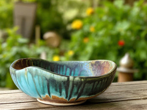 Handmade ceramic serving bowl with green and brown glaze