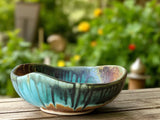Handmade ceramic serving bowl with green and brown glaze