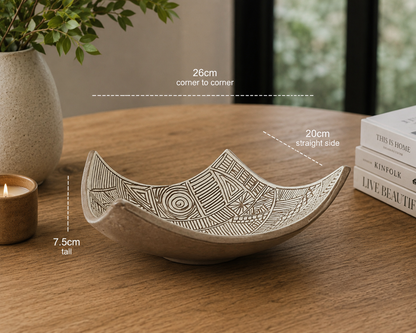 Hero image of carved white slip ceramic drape bowl displayed on timber table with modern home décor styling