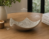 Hero image of carved white slip ceramic drape bowl displayed on timber table with modern home décor styling