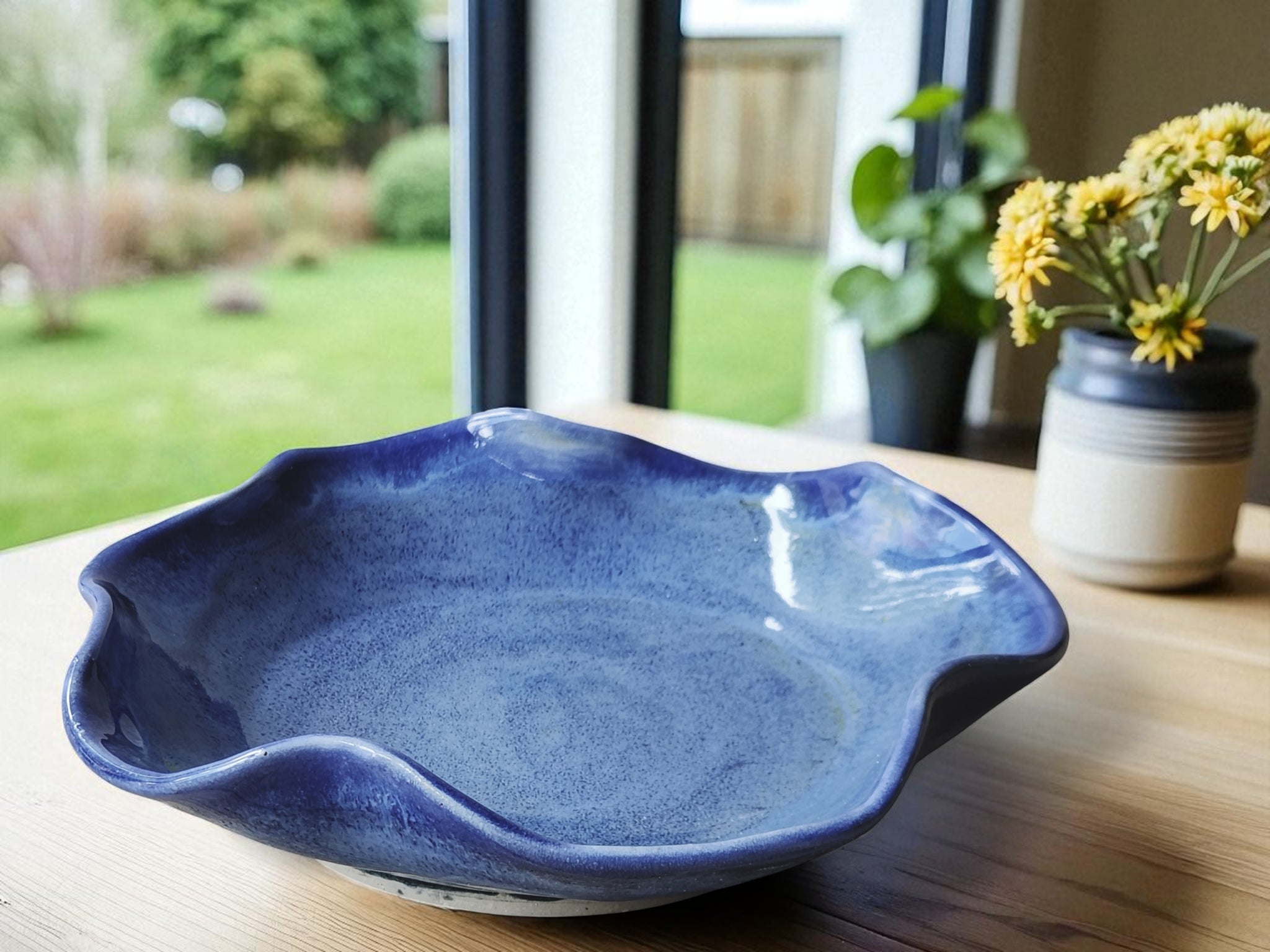 Handmade ceramic wavy bowl in blue glaze