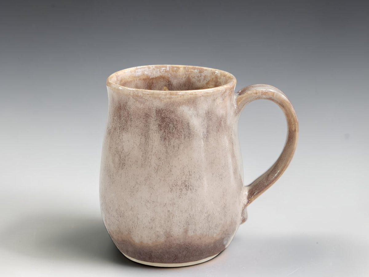 Front view of tall soft brown handmade ceramic mug