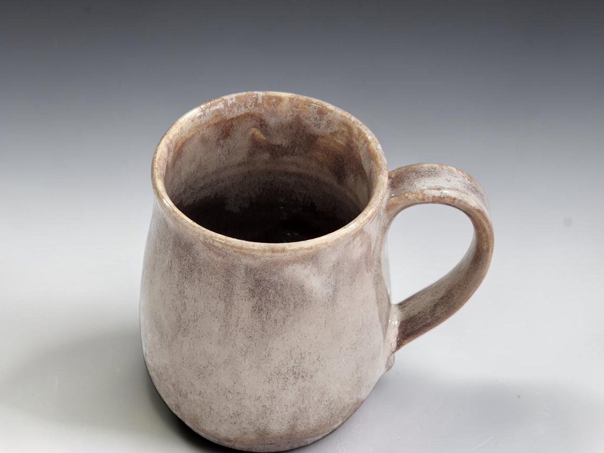 Soft brown stoneware mug with warm white mottled glaze