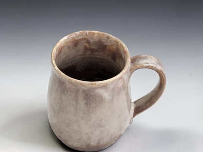 Soft brown stoneware mug with warm white mottled glaze