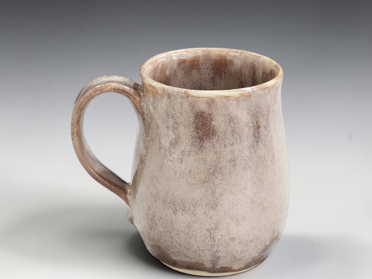 Tall neutral-toned ceramic mug with softly rounded base
