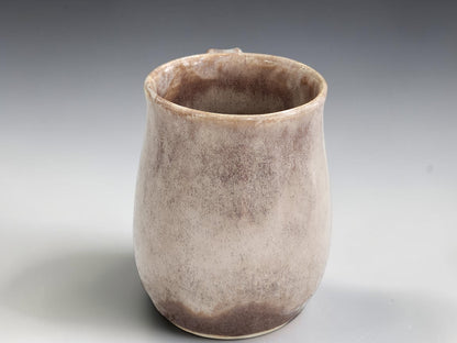 White overlay detail on handmade soft brown stoneware mug
