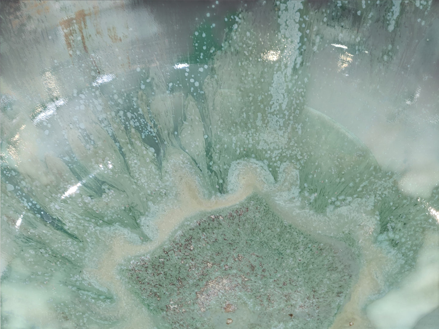 Close-up of Bush Creek Mist flowing glaze inside handmade stoneware bowl