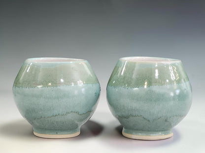 Handmade ceramic tea cups with 250ml capacity, finished in a unique mottled green glaze that highlights the beauty of artisan pottery.