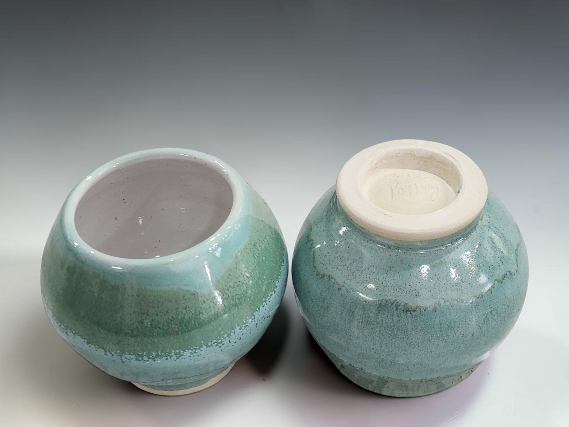 Wheel-thrown stoneware teacups featuring layered green glazes and a comfortable rounded shape, handmade in Melbourne, Australia.
