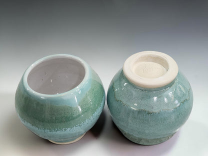 Wheel-thrown stoneware teacups featuring layered green glazes and a comfortable rounded shape, handmade in Melbourne, Australia.