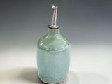 Artisan ceramic olive oil dispenser handmade in Melbourne, featuring a distinctive mottled green glaze and contemporary Australian pottery design.