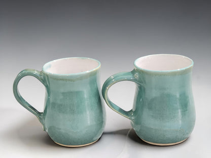 Artisan ceramic coffee mug handmade in Melbourne, featuring layered green glazes that create unique variations on every piece.