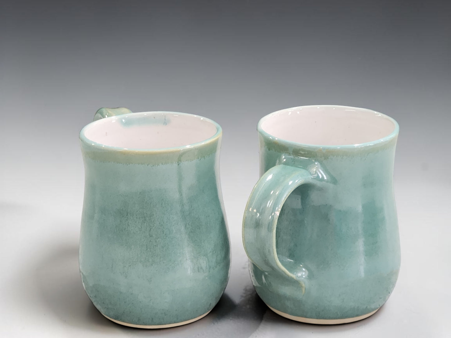 Handmade ceramic mug in a contemporary green glaze, designed for everyday coffee and tea drinking with artisan craftsmanship.