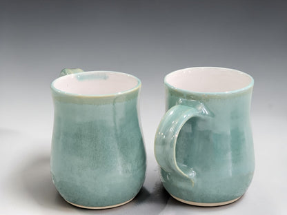 Handmade ceramic mug in a contemporary green glaze, designed for everyday coffee and tea drinking with artisan craftsmanship.