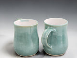 Handmade ceramic mug in a contemporary green glaze, designed for everyday coffee and tea drinking with artisan craftsmanship.