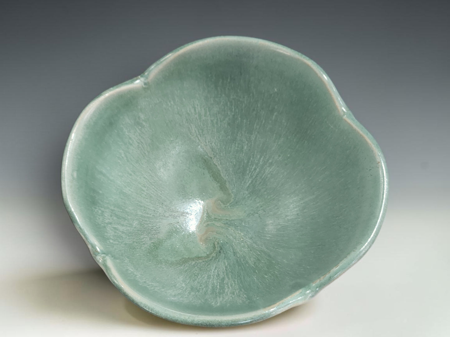 Wheel-thrown pottery bowl altered by hand with added clay and reshaped rim detail