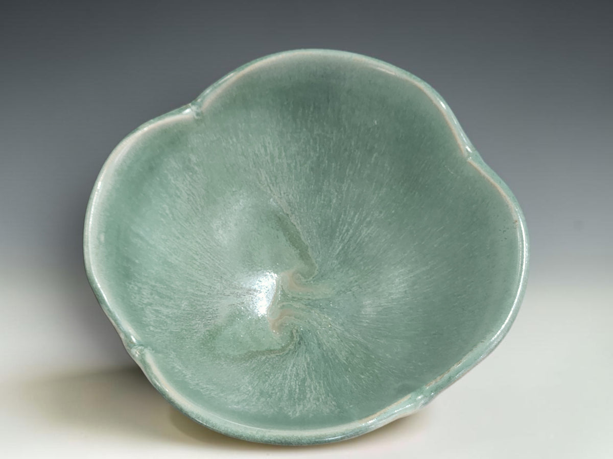 Wheel-thrown pottery bowl altered by hand with added clay and reshaped rim detail