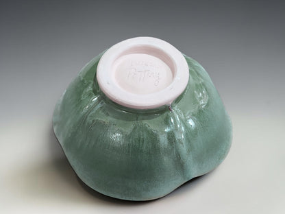 Handmade altered stoneware bowl with glossy green interior and unique handmade finish  showing the bottom with the makers mark