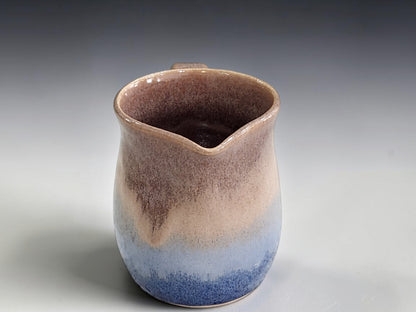 Australian handmade pottery jug with soft brown and deep blue glaze