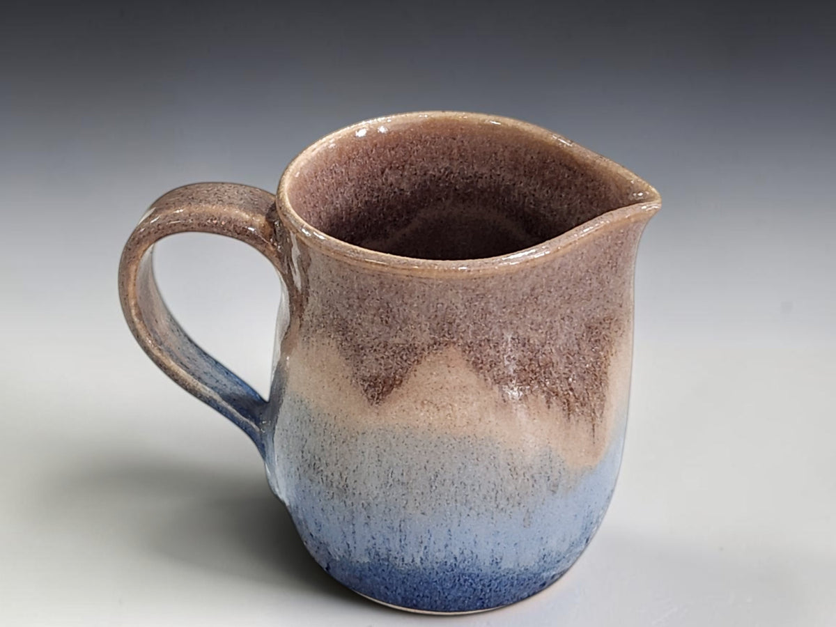 Unique pottery cream jug with soft grey-blue glaze detail