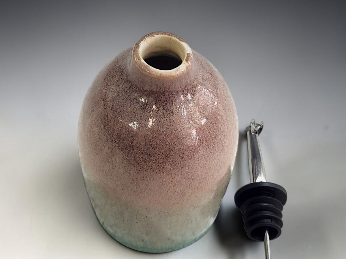Top view of the green and brown glazed handmade oil bottle.