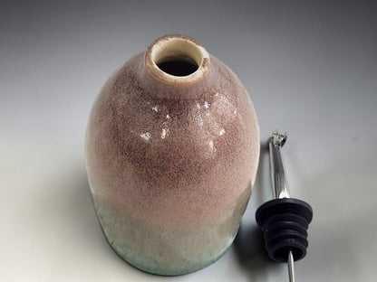 Top view of the green and brown glazed handmade oil bottle.