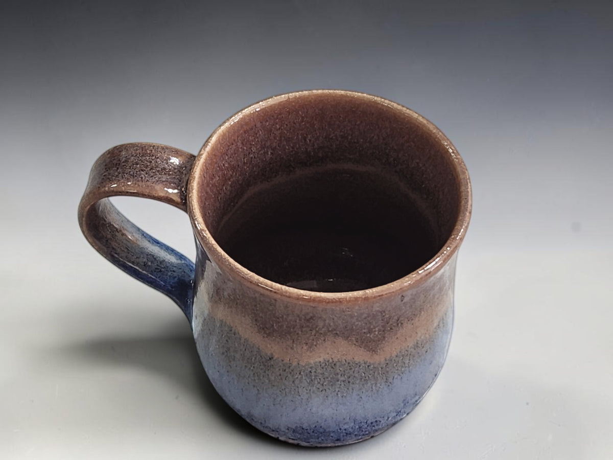 internal view of a Handmade pottery mug showing natural layered glaze variations